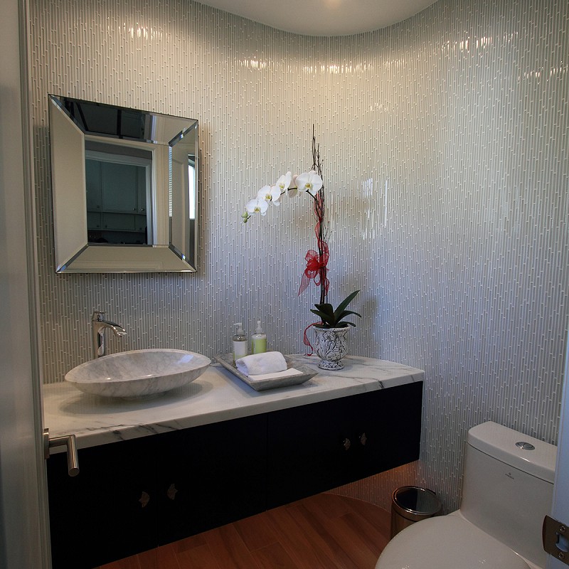 Remodeled bathroom featuring wrap-around tile.